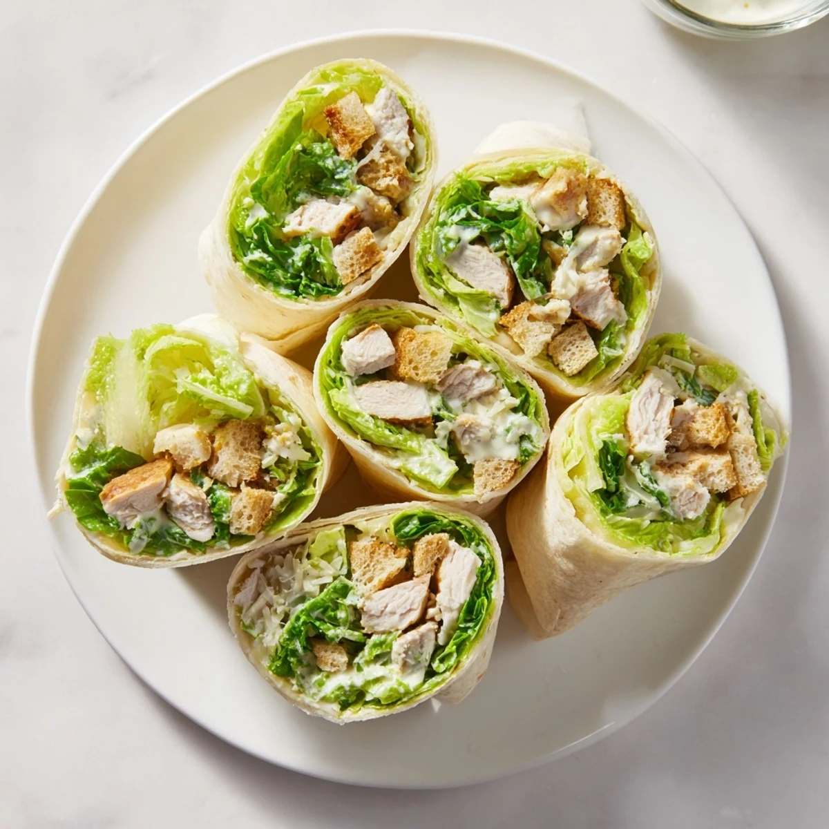 Delicious Chicken Caesar Wraps filled with grilled chicken, Parmesan, and crunchy croutons in a warm tortilla.
