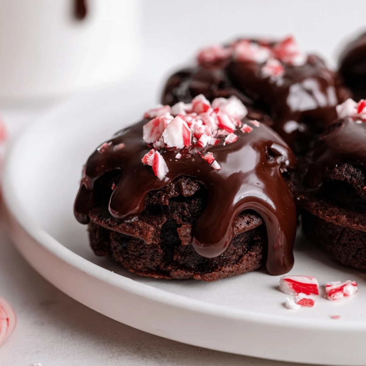 Mini muffin tin filled with perfectly baked Peppermint Mocha Brownie Bites, rich with cocoa and peppermint.