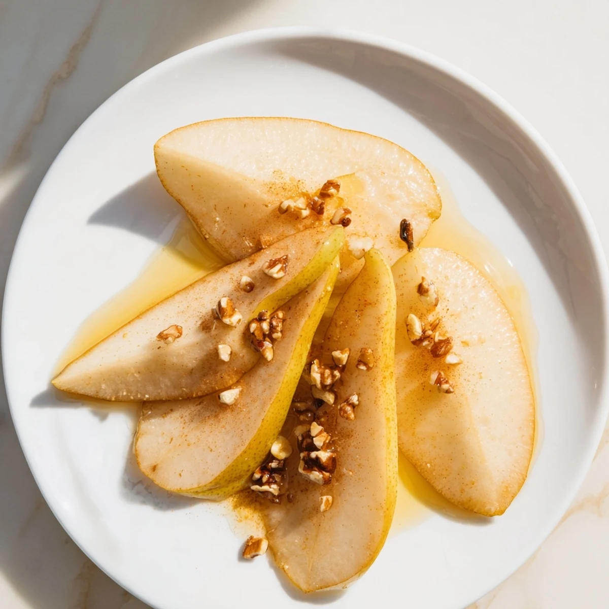Fresh, juicy pear slices with golden honey drizzle, making a simple, elegant treat.