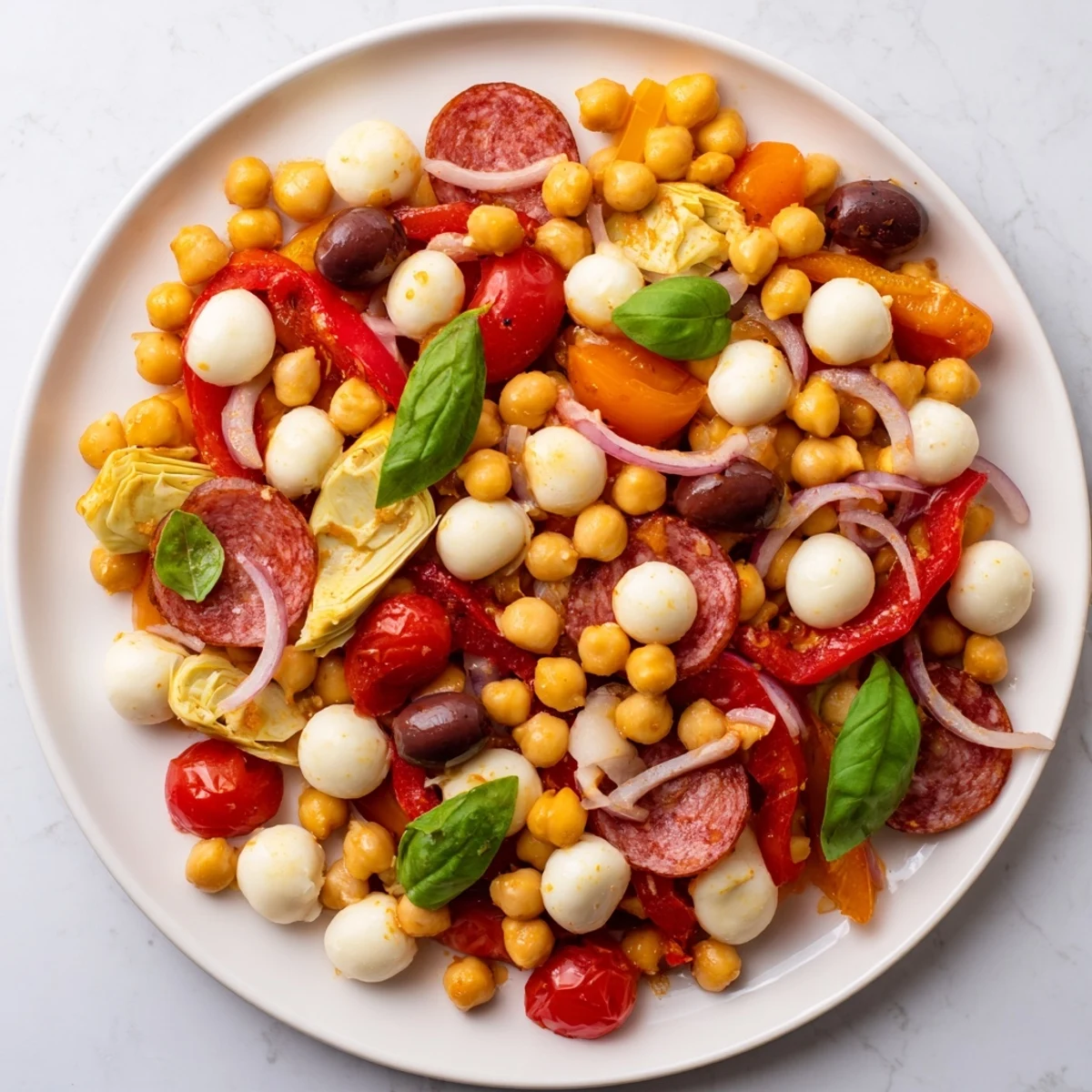 Vibrant Antipasto Chickpea Salad overflowing with colorful vegetables and creamy mozzarella in a tangy vinaigrette.