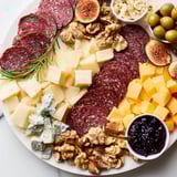 Visualize the Deer Antler Charcuterie, a gorgeous arrangement with grapes and rye crackers.