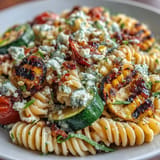 Smoky Pasta Salad with Grilled Zucchini and Sweet Corn, topped with crumbly Cotija.