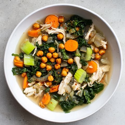 Chicken Kale Soup with crispy chickpeas, a bowl filled with hearty, savory goodness, ready to eat.