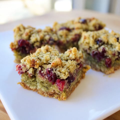 Golden-brown Matcha Cranberry Oat Crumble Breakfast Bars, with a delicious crumble topping and tart cranberries.