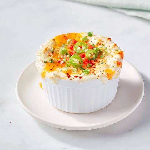 Molten lava flow volcano dip bubbling with melted cheese, served with an array of dippers.