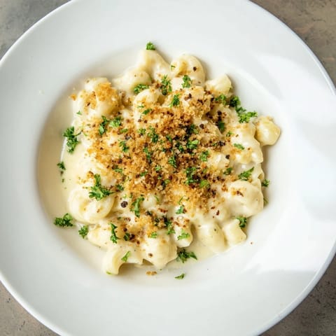 A close-up of creamy Truffle Macaroni & Cheese, showcasing the indulgent truffle oil and melted cheese blend.