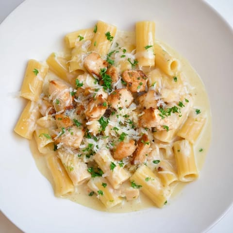 A close-up of Creamy Garlic Parmesan Chicken Rigatoni with parsley garnish, perfect for dinner.