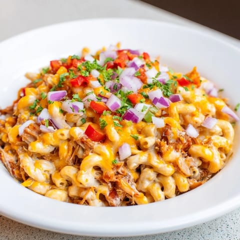 This saucy BBQ Rib Macaroni Skillet features tender pulled pork and creamy, cheesy pasta.