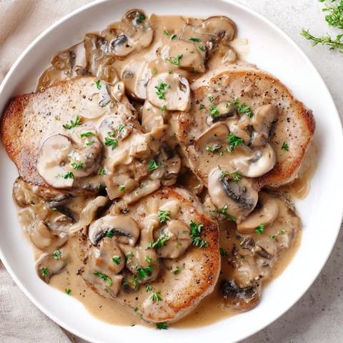 Tender, juicy stove top pork chops with rich cream of mushroom sauce; a comforting meal.