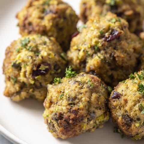These perfectly round Quick Christmas Stuffing Balls, crispy outside, showcase warm bread and herbs, perfect side.
