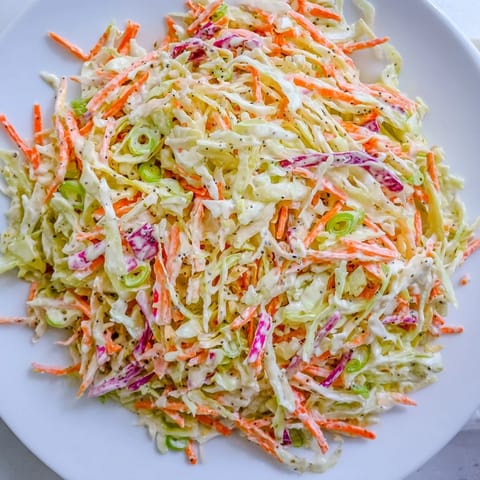 Homemade Quick Coleslaw Salad, boasting colorful shredded veggies, ready to enjoy alongside barbecue.