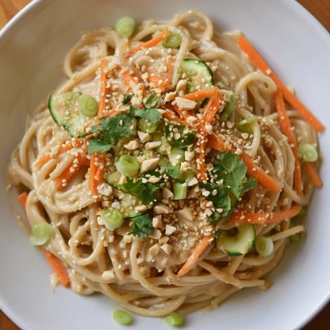 A close-up of cold sesame noodles, creamy and flavorful, ready to be enjoyed as a refreshing meal.