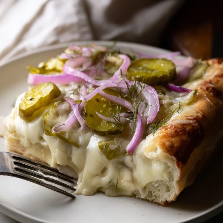 Delicious, golden-brown Pickle Pizza topped with rich mozzarella and zesty flavors.