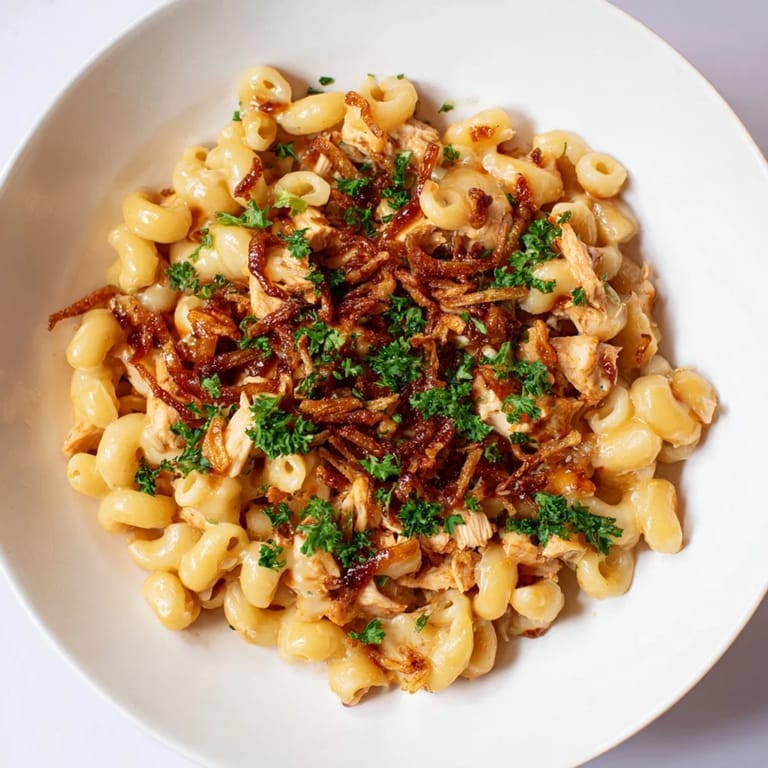 A bubbling skillet of One-Pot Honey BBQ Chicken Mac and Cheese, ready to be served hot and creamy.