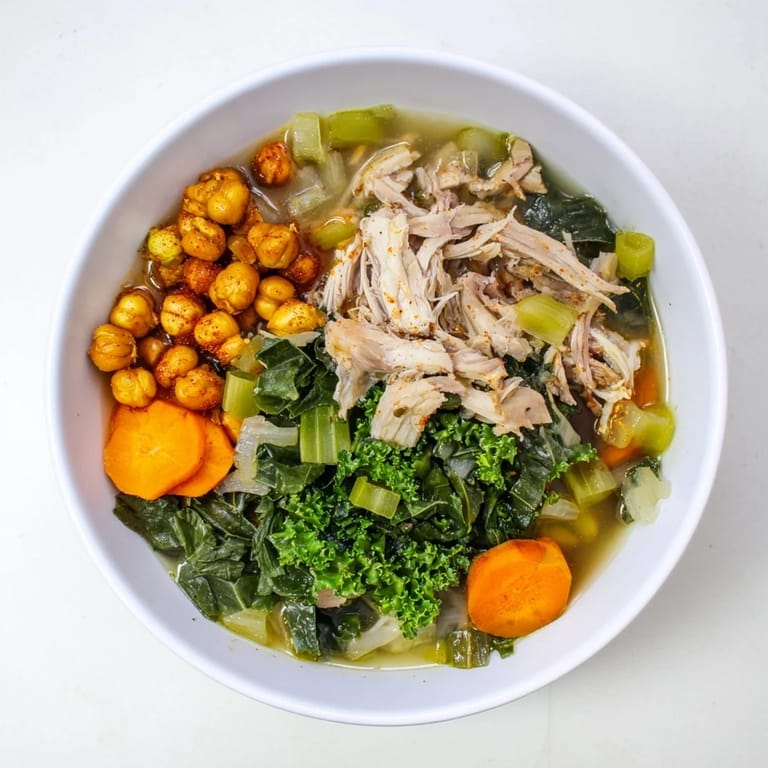 Golden, crispy chickpeas crown a rich Chicken Kale Soup, perfect for a warming, flavorful meal.