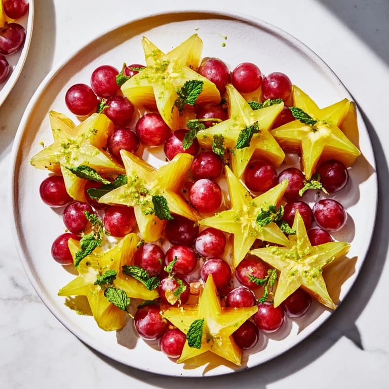 Freshly arranged sliced starfruit and juicy grapes making a colorful, healthy fruit plate for brunch.