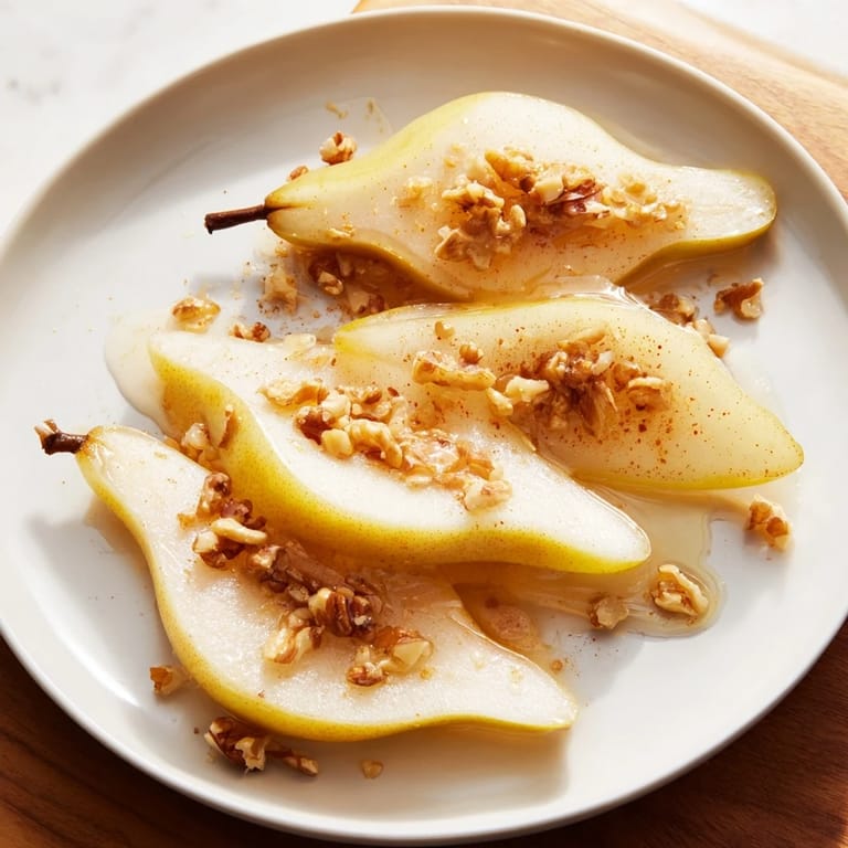 Beautifully arranged pear slices crowned with sweet honey, perfect as a quick snack or dessert.