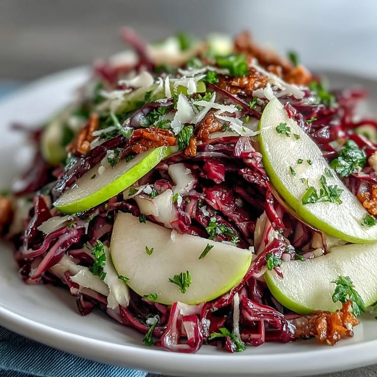 Easy Red Cabbage Coleslaw With Apple and Parmesan salad mixed with bright green onions and glistening dressing, perfect for a gluten-free meal prep lunch.